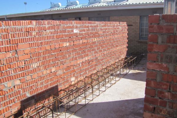 steel beams brick wall rooftop sky
