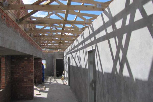 wooden roof supports hallway cement walls