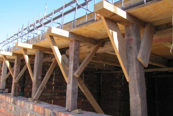 wooden supports brick wall outside view