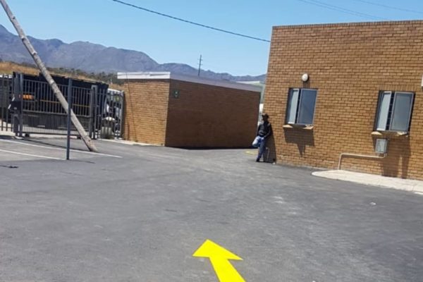 yellow arrow drive way man standing